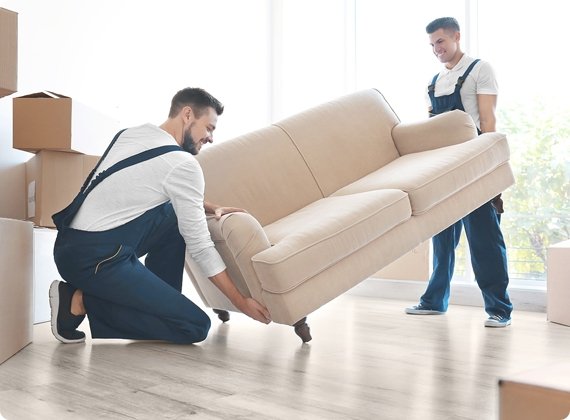 Two movers moving a sofa